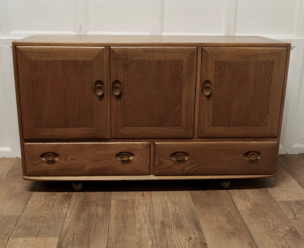 a mid century golden elm sideboard by ercol