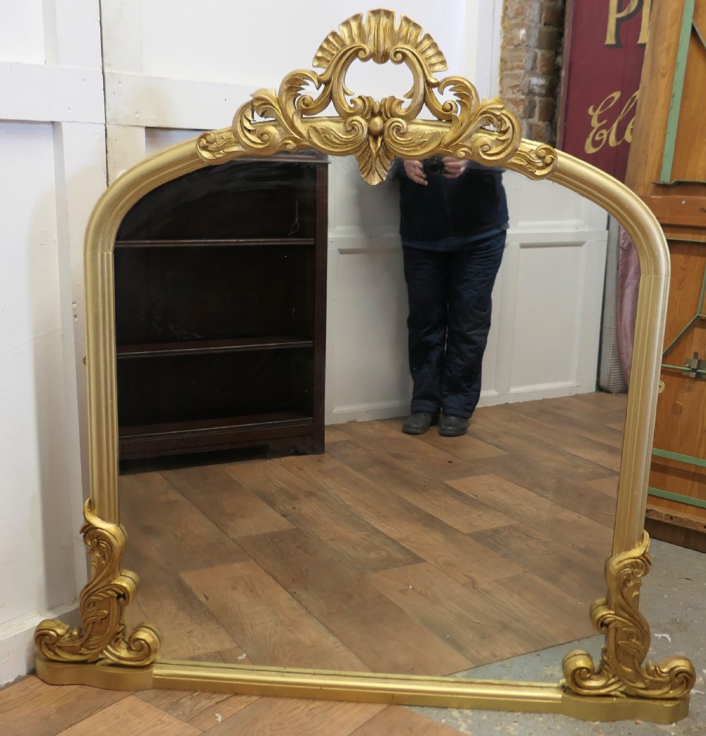 large gilt rococo style arched over mantle mirror