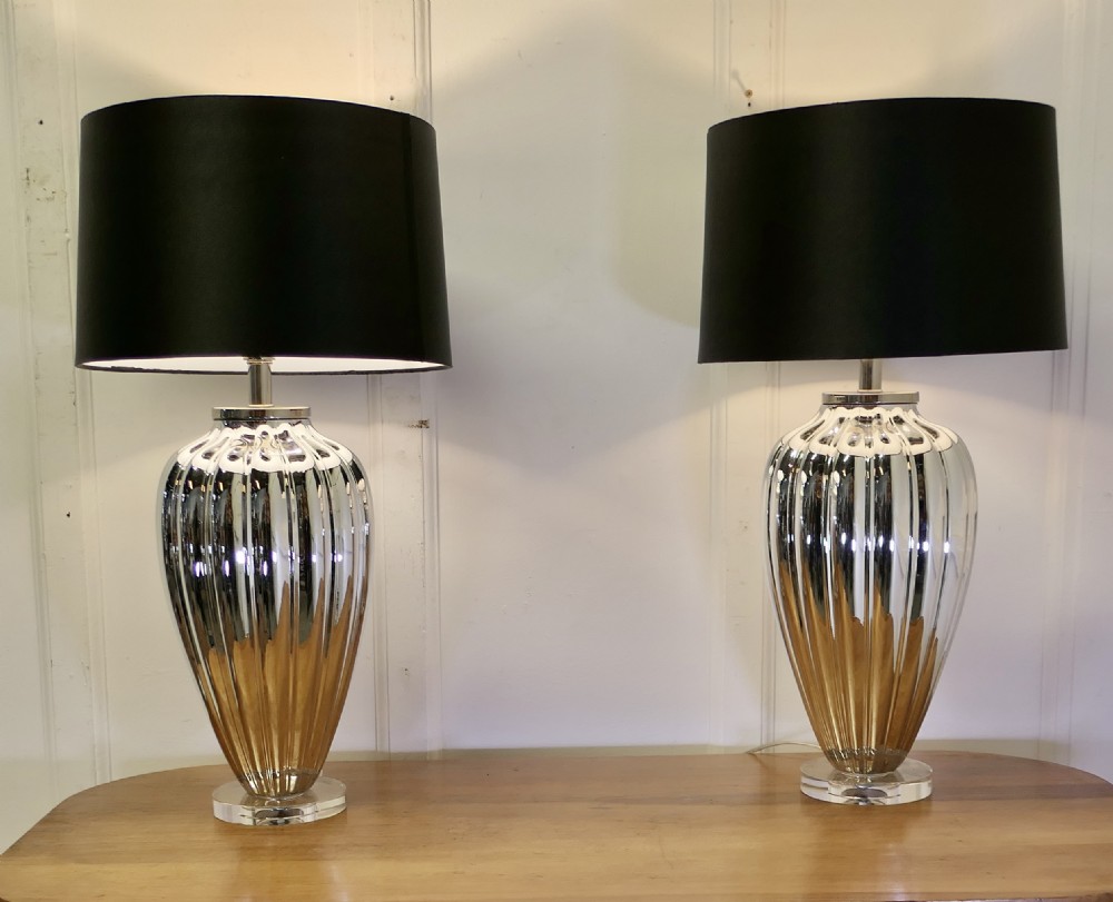 a pair of silvered glass table lamps