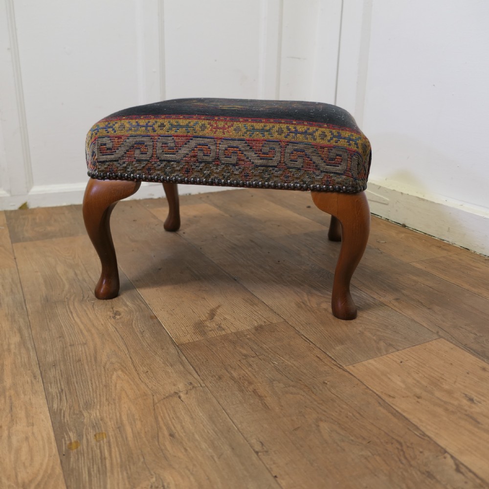 a petit point embroidered tapestry upholstered stool