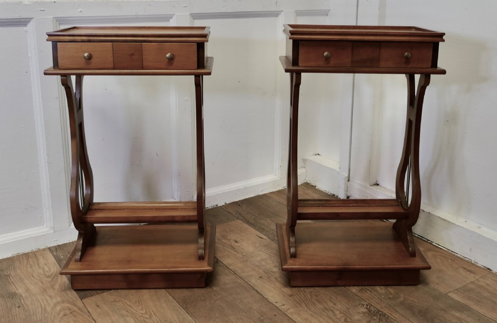 an unusual pair of lyre ended cherrywood lamp or side tables