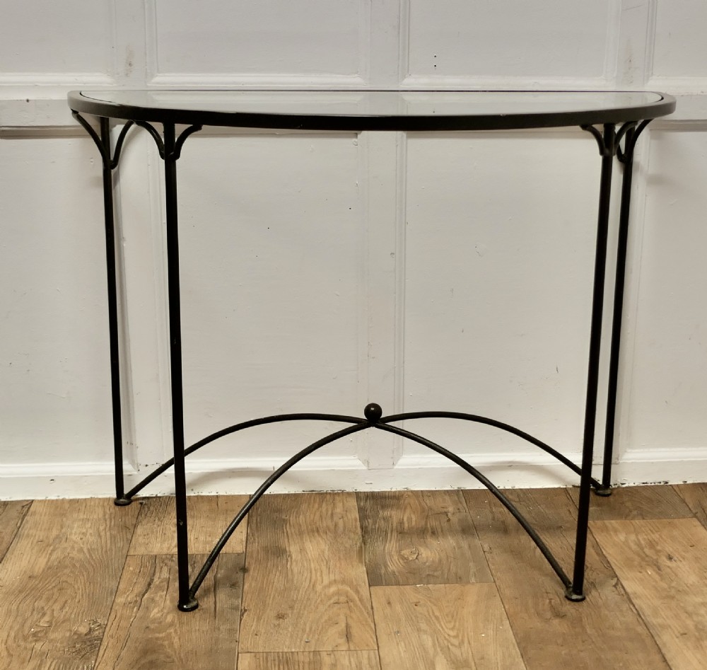 a stylish iron and glass console table