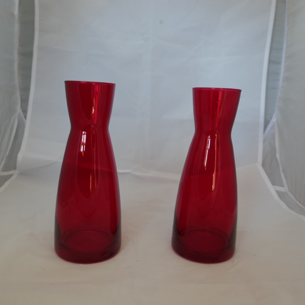 a pair of ypsilon red glass carafes by bormioli rocco