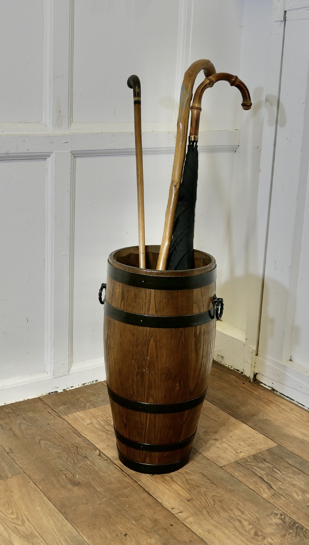 a large golden oak iron bound barrel stick stand