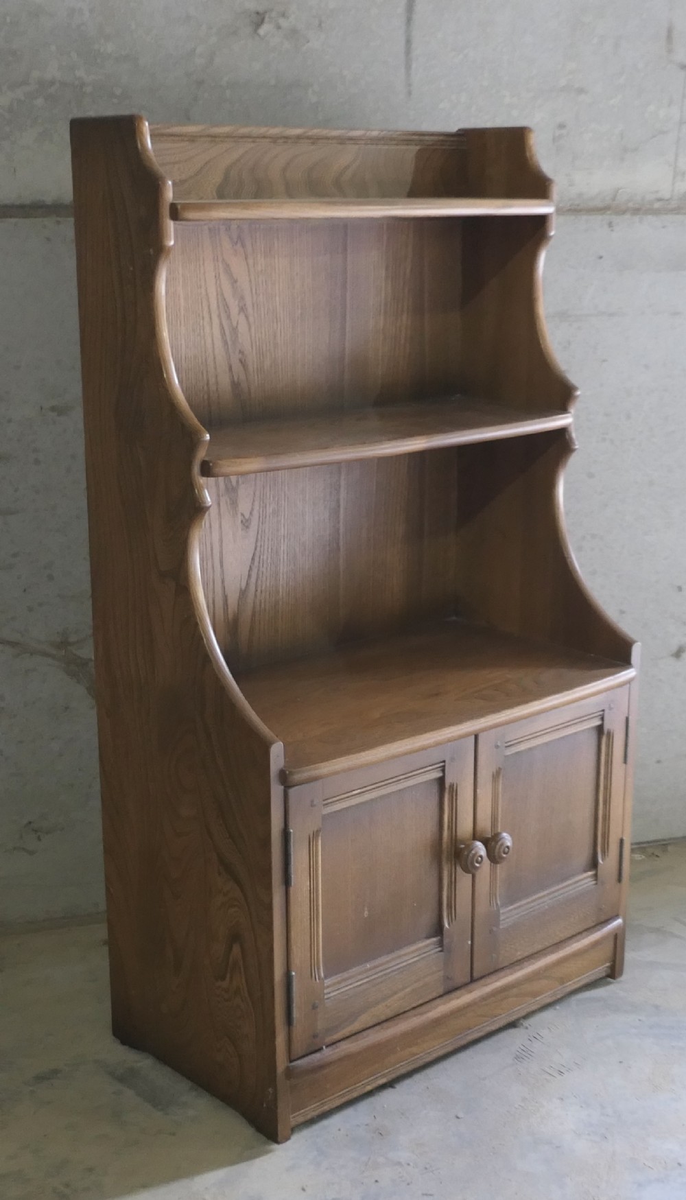 ercol waterfall golden elm bookcase with cupboard