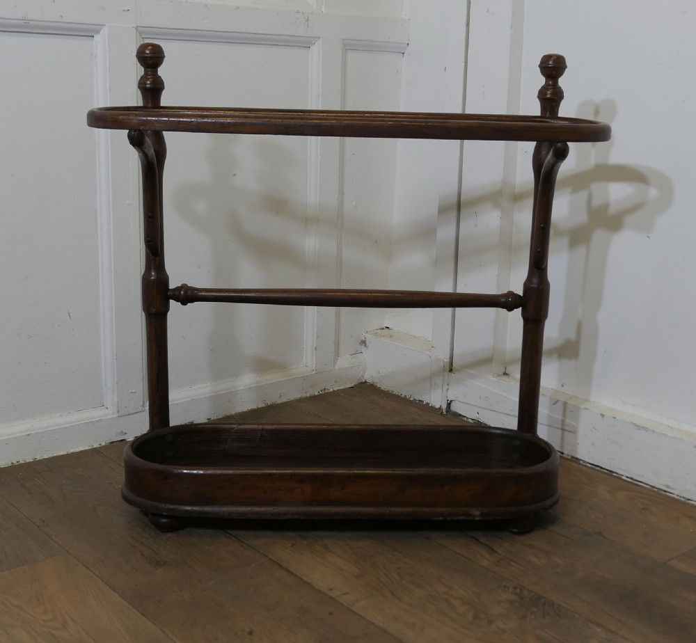 a long bentwood stick stand or umbrella stand