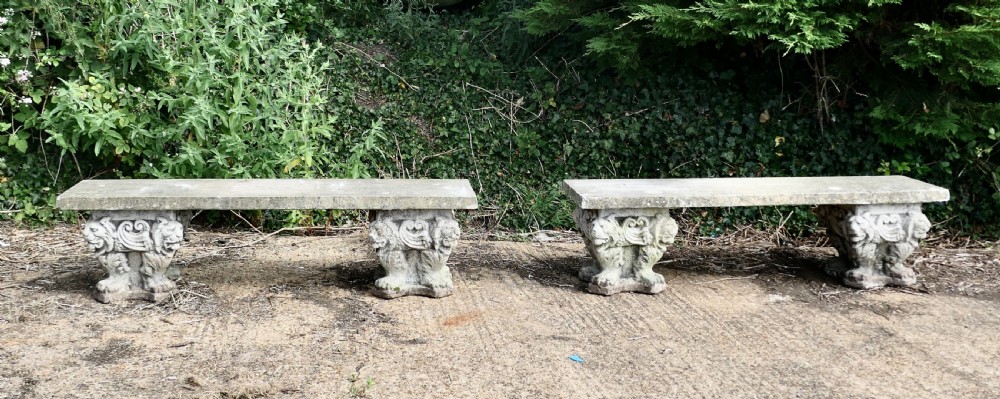 a pair of old gothic weathered stone garden benches