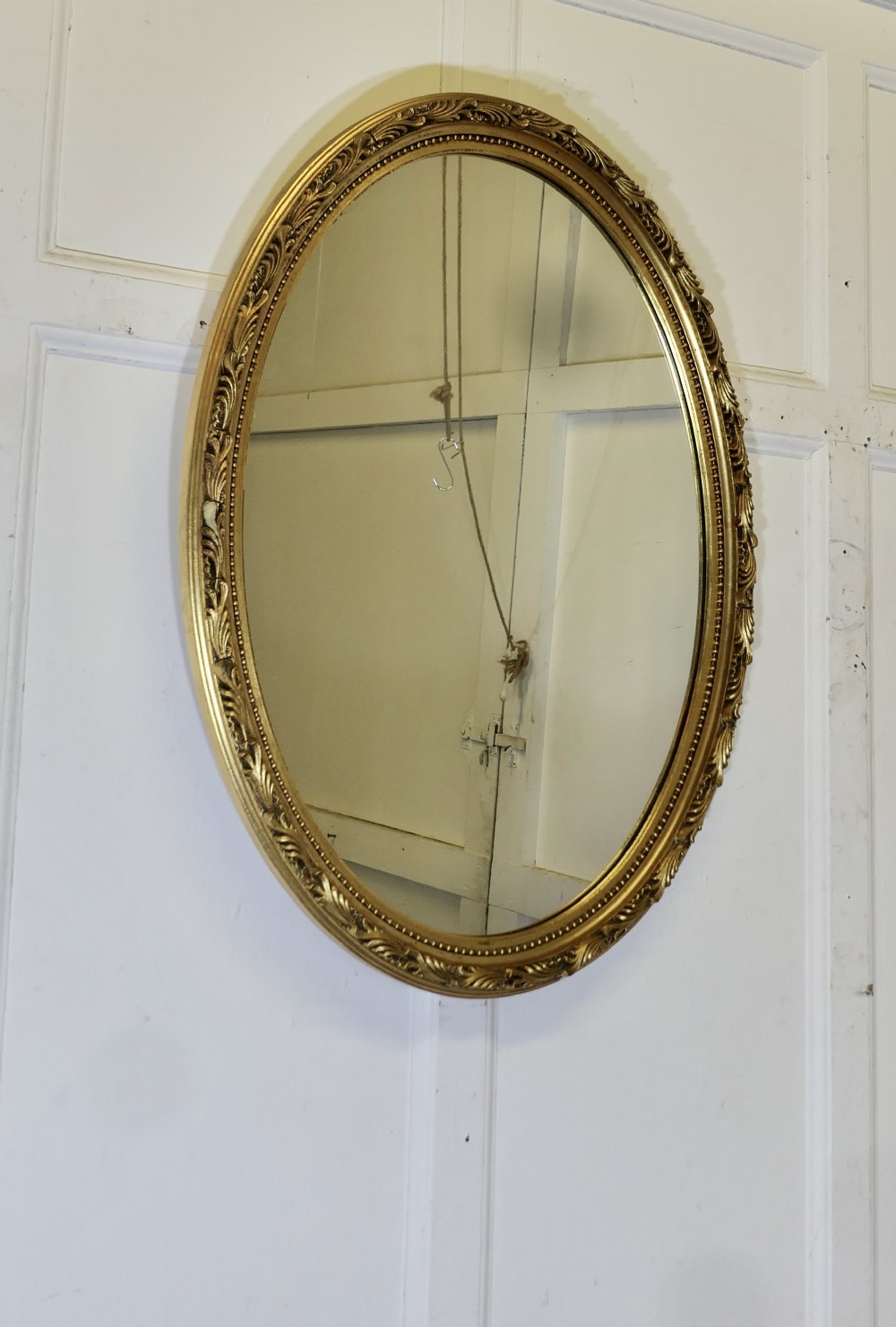 large decorative gilt oval mirror