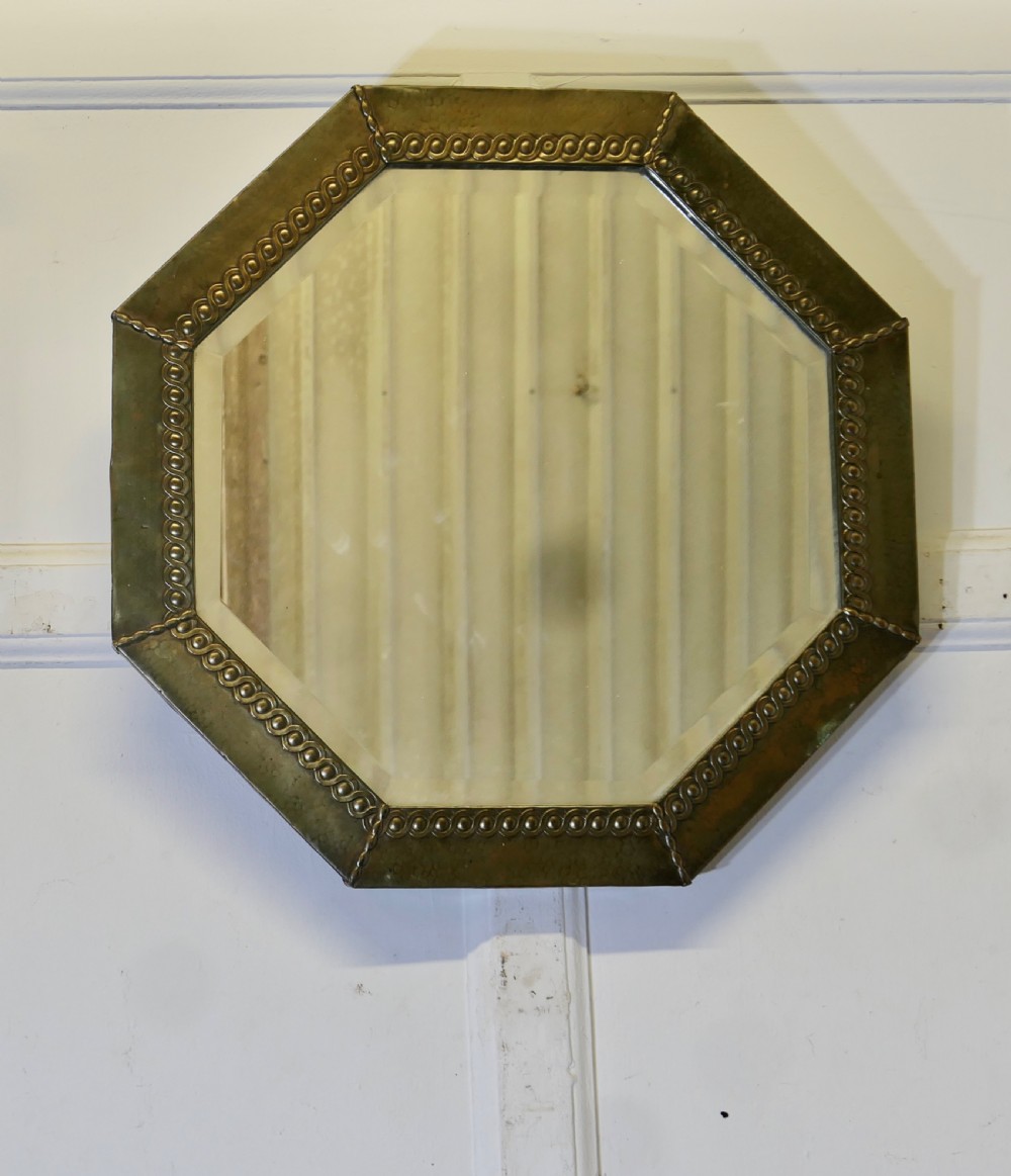 an arts and crafts beaten brass mirror