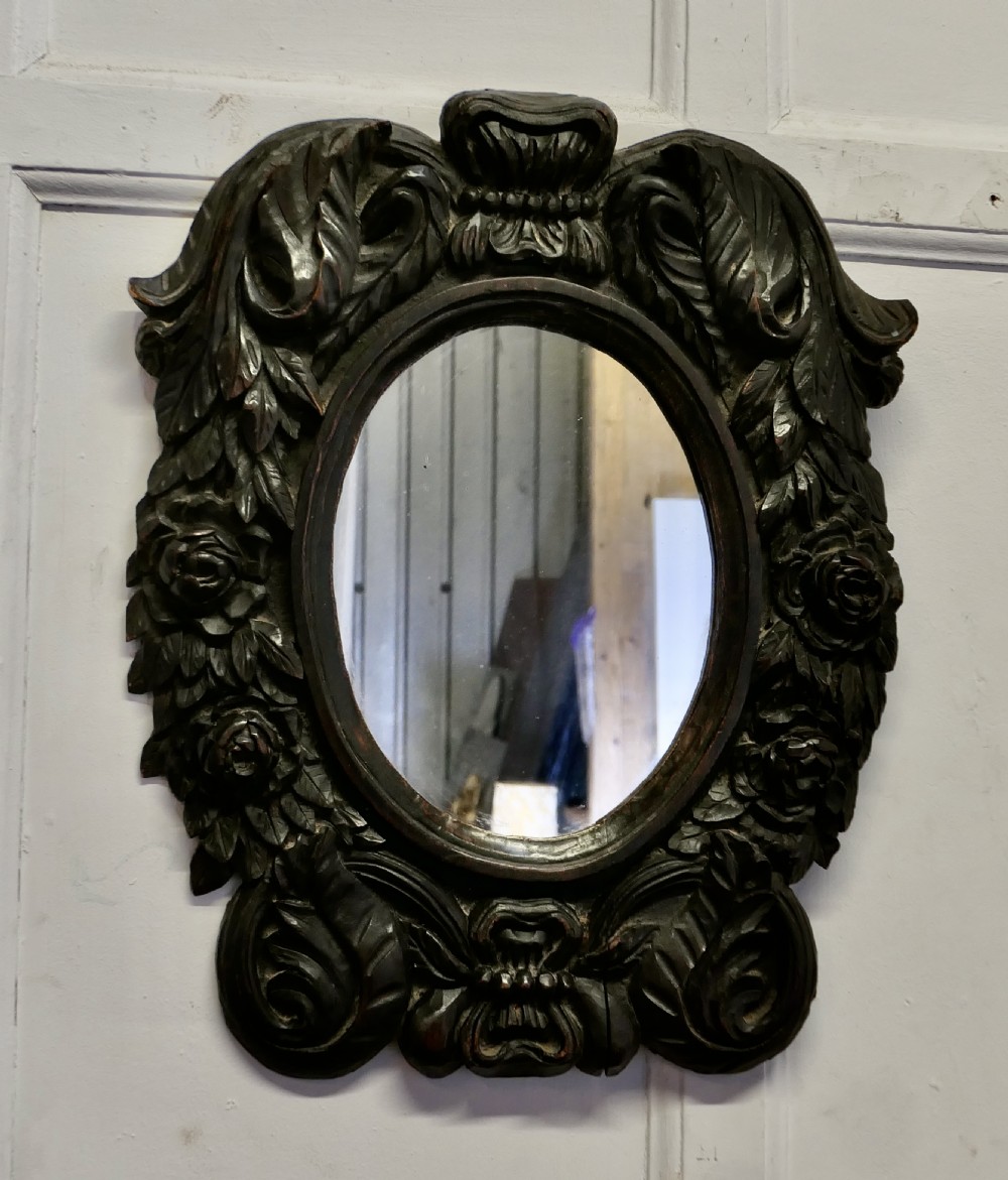 gothic carved oak oval mirror