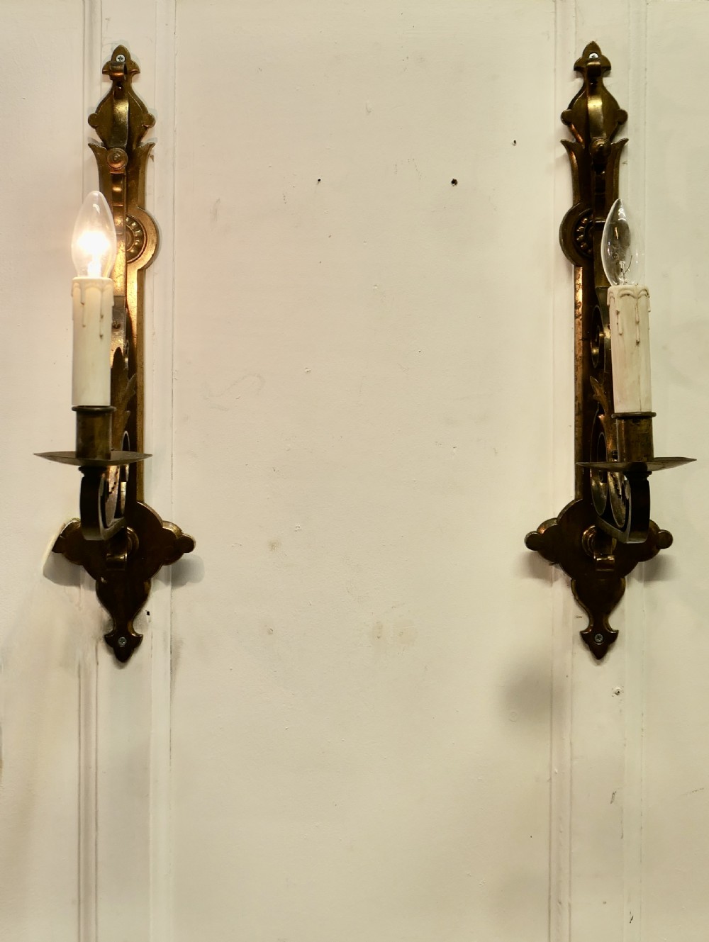 a pair of large gilded brass wall lights