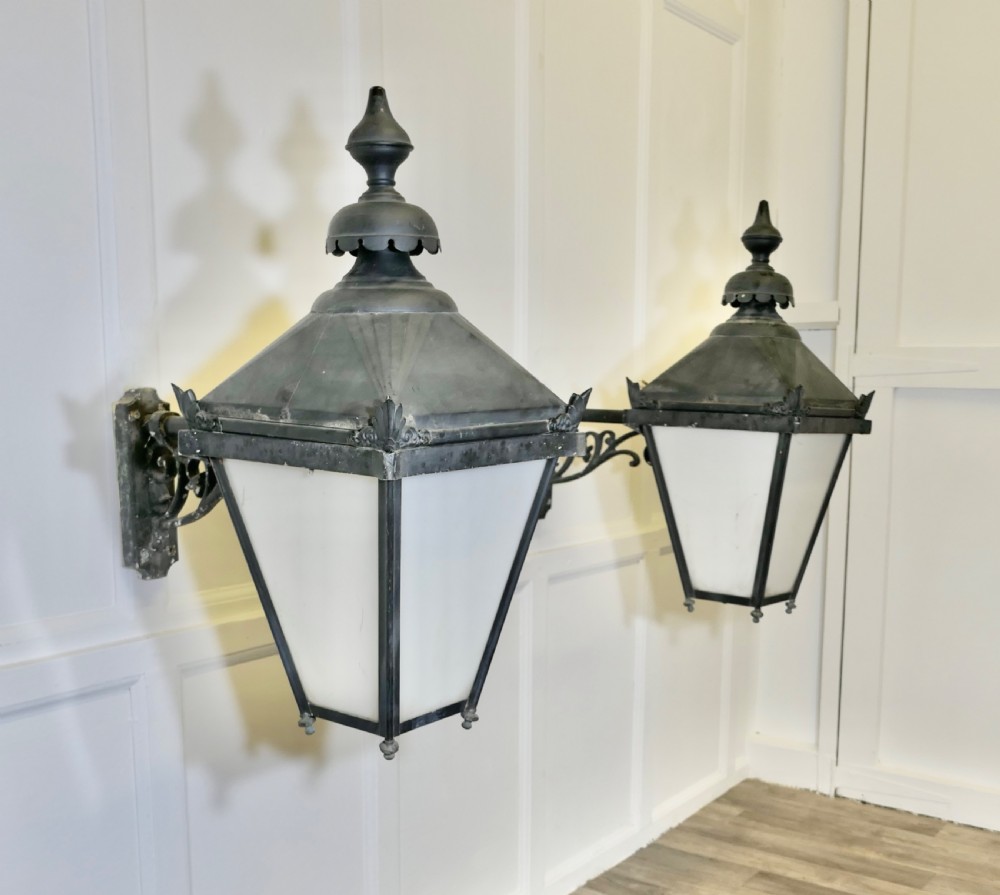 a pair of large painted copper wall hung lanterns