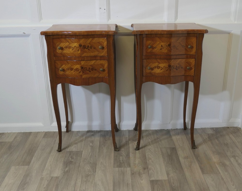 a pair of inlaid french serpentine shaped bedside cabinets