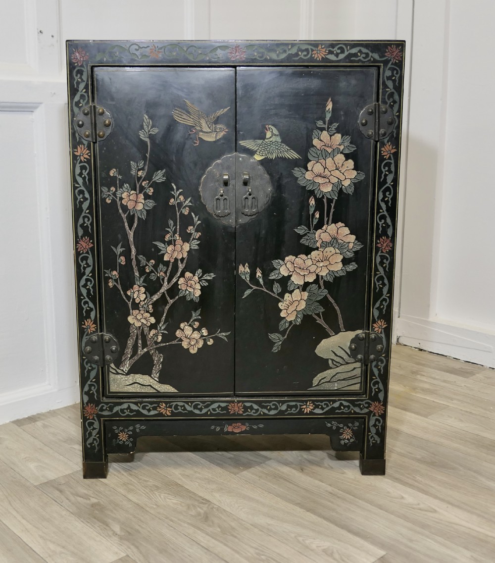 black chinoiserie lacquer cupboard decorated with birds and flowers