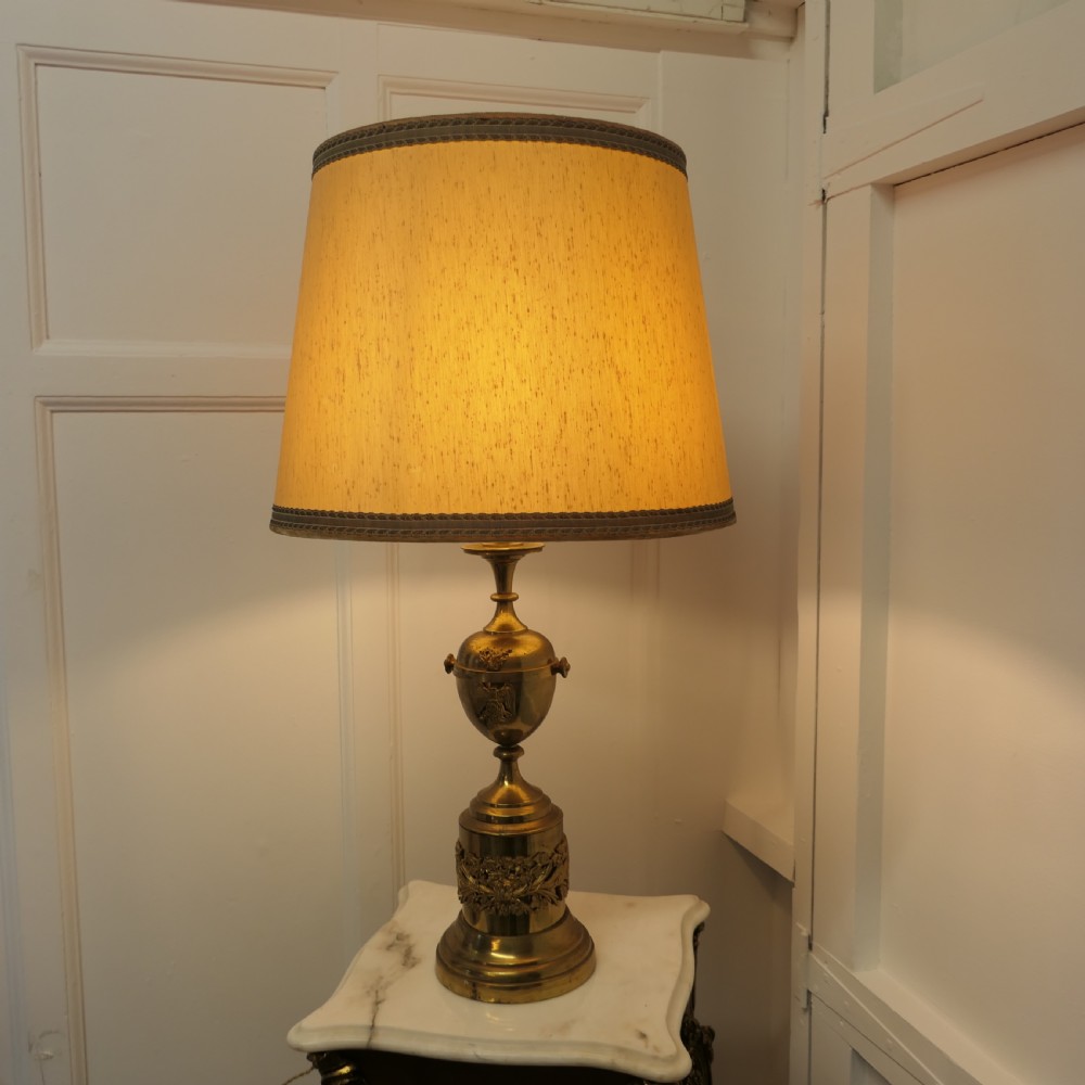 brass table lamp with italian classical mask and mounts to the base