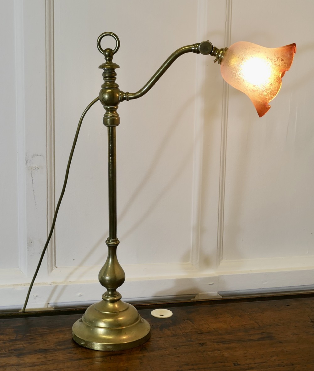 french brass desktable lamp with detailed pinkamber glass shade