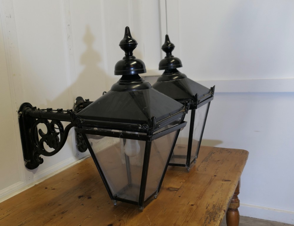 a pair of large painted copper wall hung pub lanterns