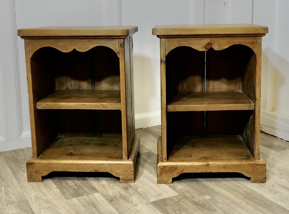 a pair of pine bedside tables with open shelves