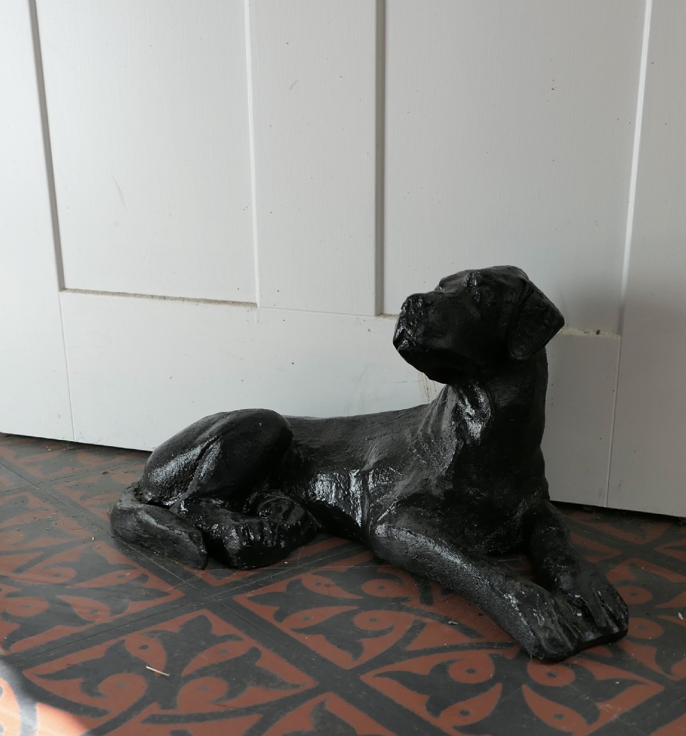 a black labrador puppy door stop