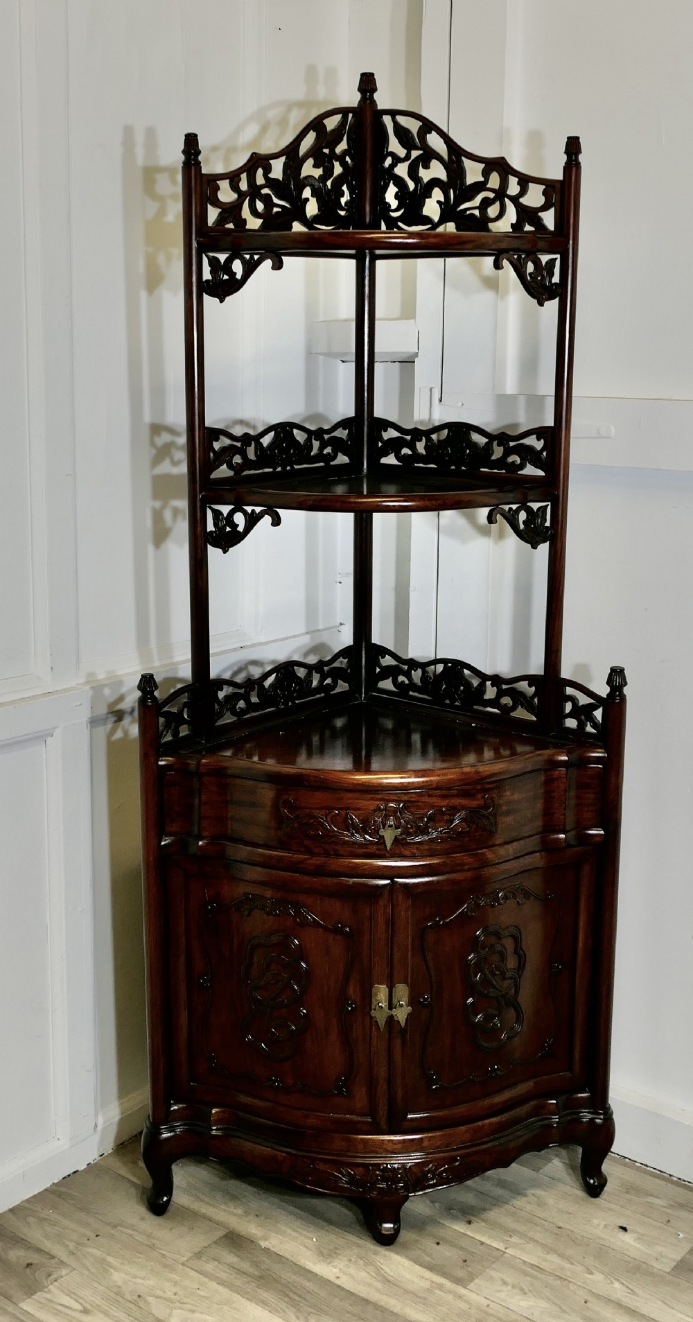 oriental style carved corner etagere with cupboard and drawer