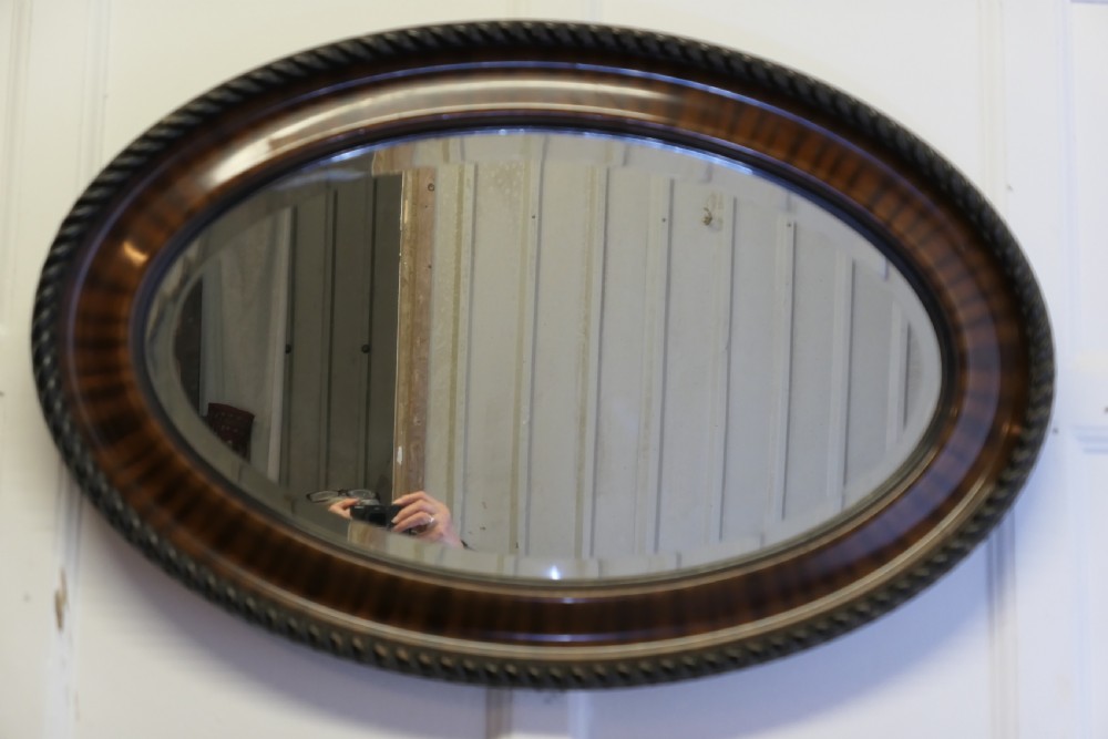 large edwardian wood finish oval mirror