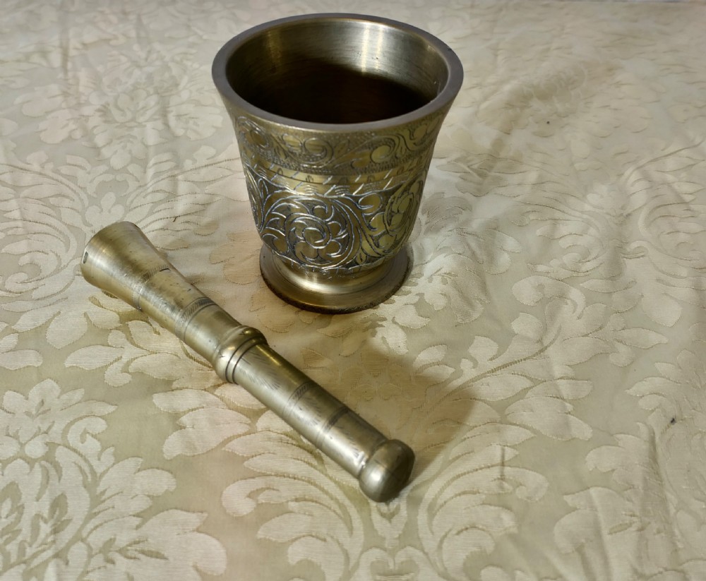 beautifully decorated brass pestle and mortar