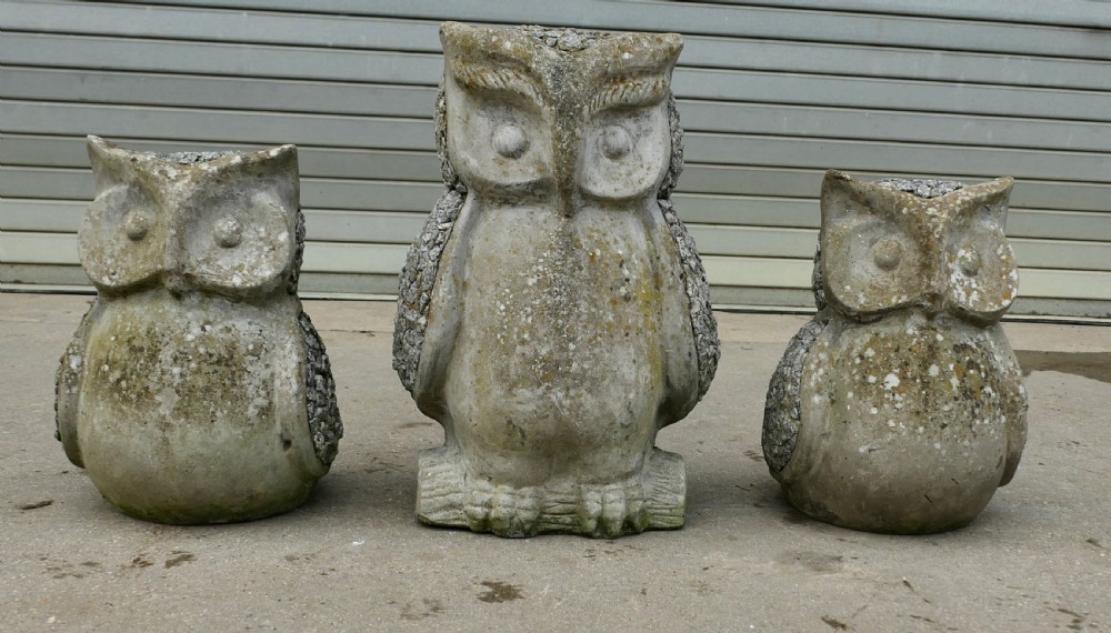 a family of 3 weathered granite owls