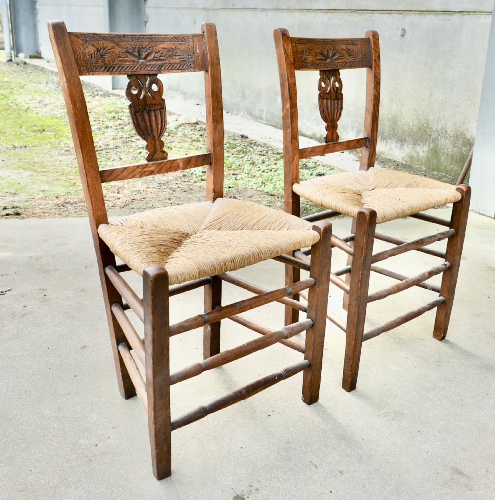 a pair of early 19th century rush seated elm hall chairs